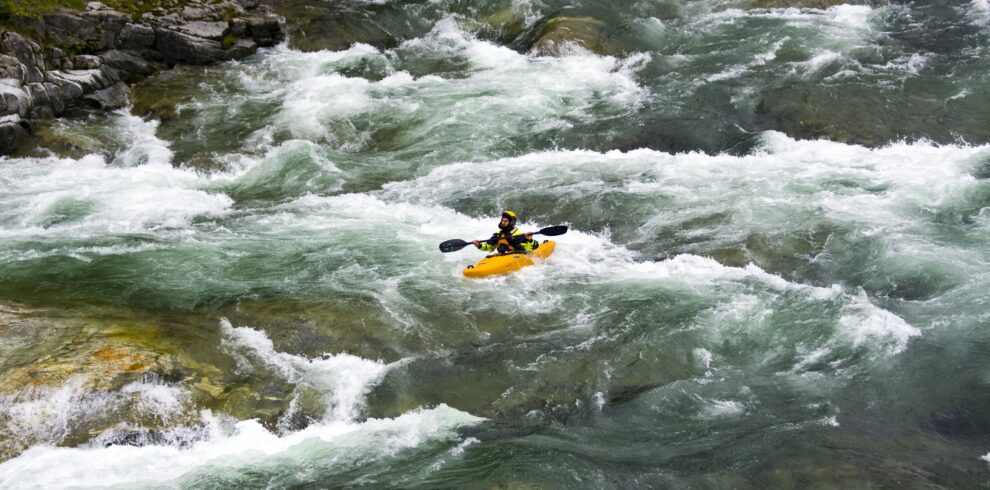 Beautiful scenery of the rafting on the mountain river stream flowing down between huge stones